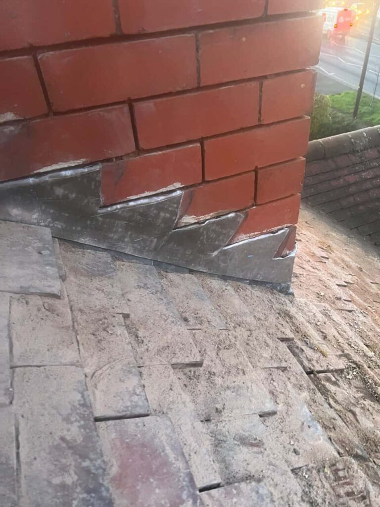 This is a photo of new leadwork being installed around an old chimney. Works carried out by Stourbridge Roofing Repairs